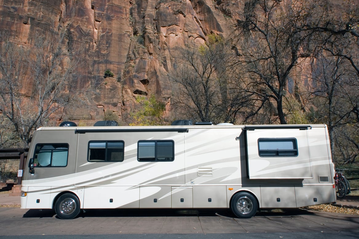 A luxury RV parked in the woods